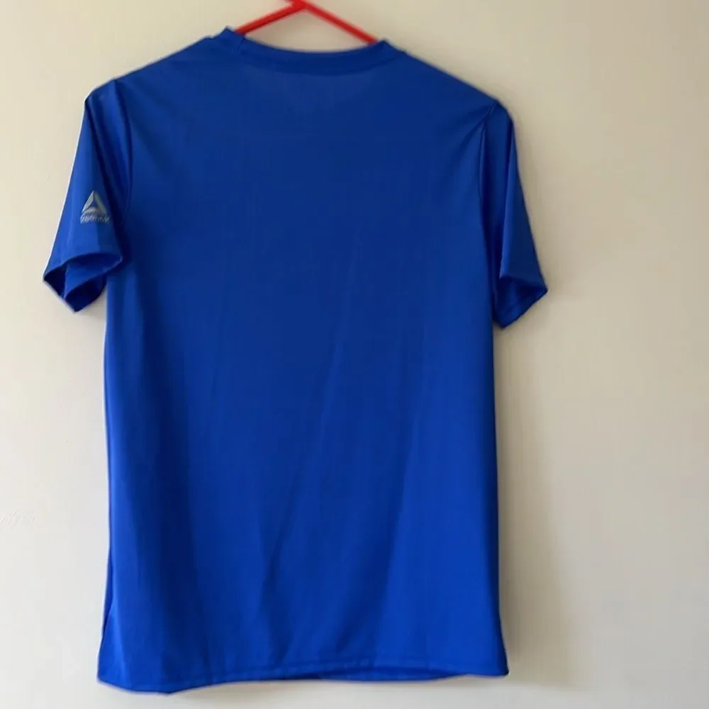 Reebok youth boys size 14-16 blue Savage on the Field shirt.